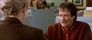 Neither funny voices nor a snarl allow Daniel Hillard (Robin Williams) to amuse the social worker (Anne Haney) he has to check in with.